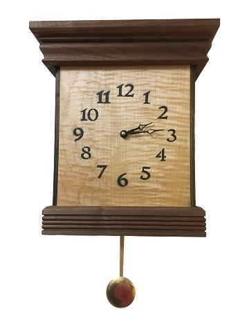 This is  a walnut and curly maple chime clock 