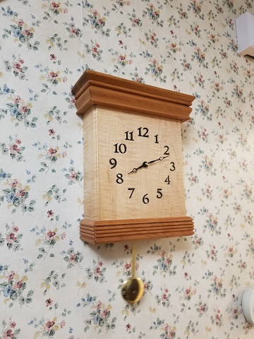 This is a West Minster chime Cherry and curly maple wood clock